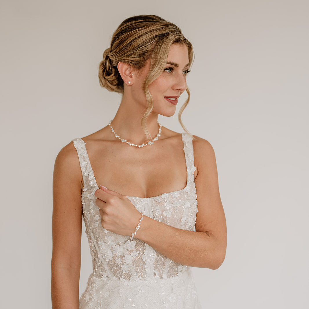 Brauthalskette Jasmin mit schwebenden veganen Perlen unterschiedlicher Größe und 925er Sterlingsilber 18K vergoldetem Verschluss, mit passendem Armband Jasmin und Ohrstecker Perla, am Model getragen