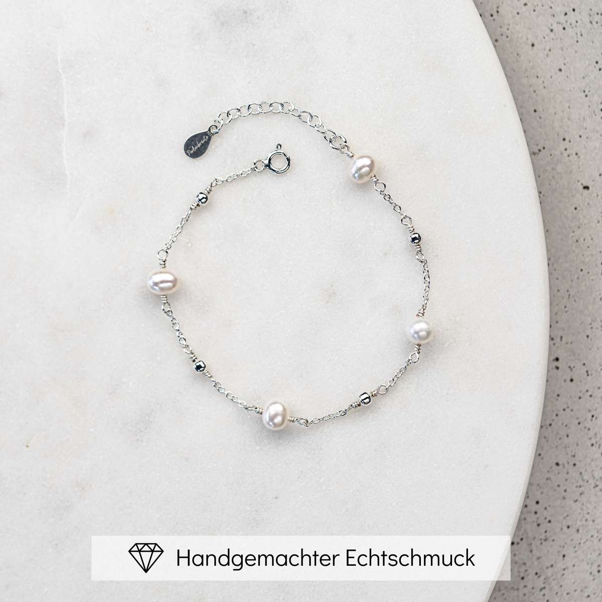 Edles Brautarmband Valli aus 925 Sterlingsilber mit echten Süßwasserperlen und kleinen Kugeln aus Metall, am Model getragen in Nahaufnahme