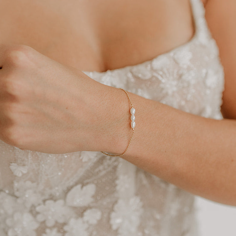 Brautarmband Amelie aus 925 Sterlingsilber 18K vergoldet mit kleinen echten Süßwasserperlen, am Model getragen in Nahaufnahme