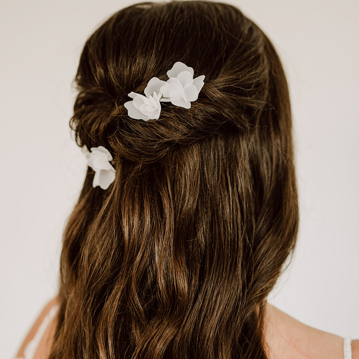 3er Set Braut Haarnadeln Flora mit weißen Stoffblüten, getragen von einem Model in Nahaufnahme