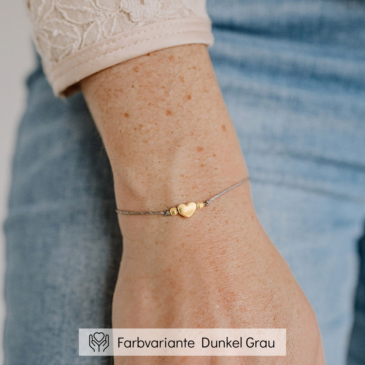Trauzeugin Armband aus grauem Makramee-Band mit goldenem Herz-Bead, am Handgelenk getragen